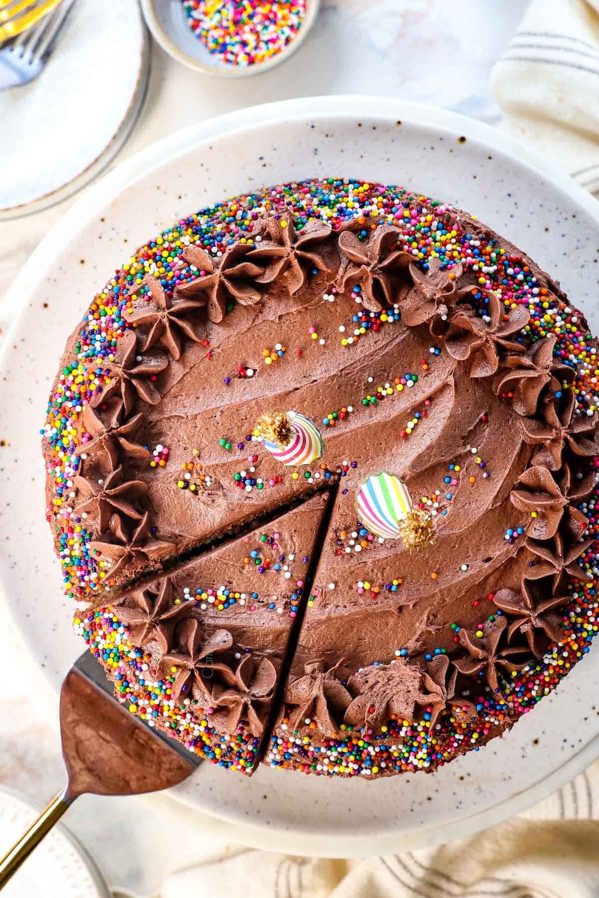 top of yellow cake recipe decorated with sprinkles on a cake pedestal
