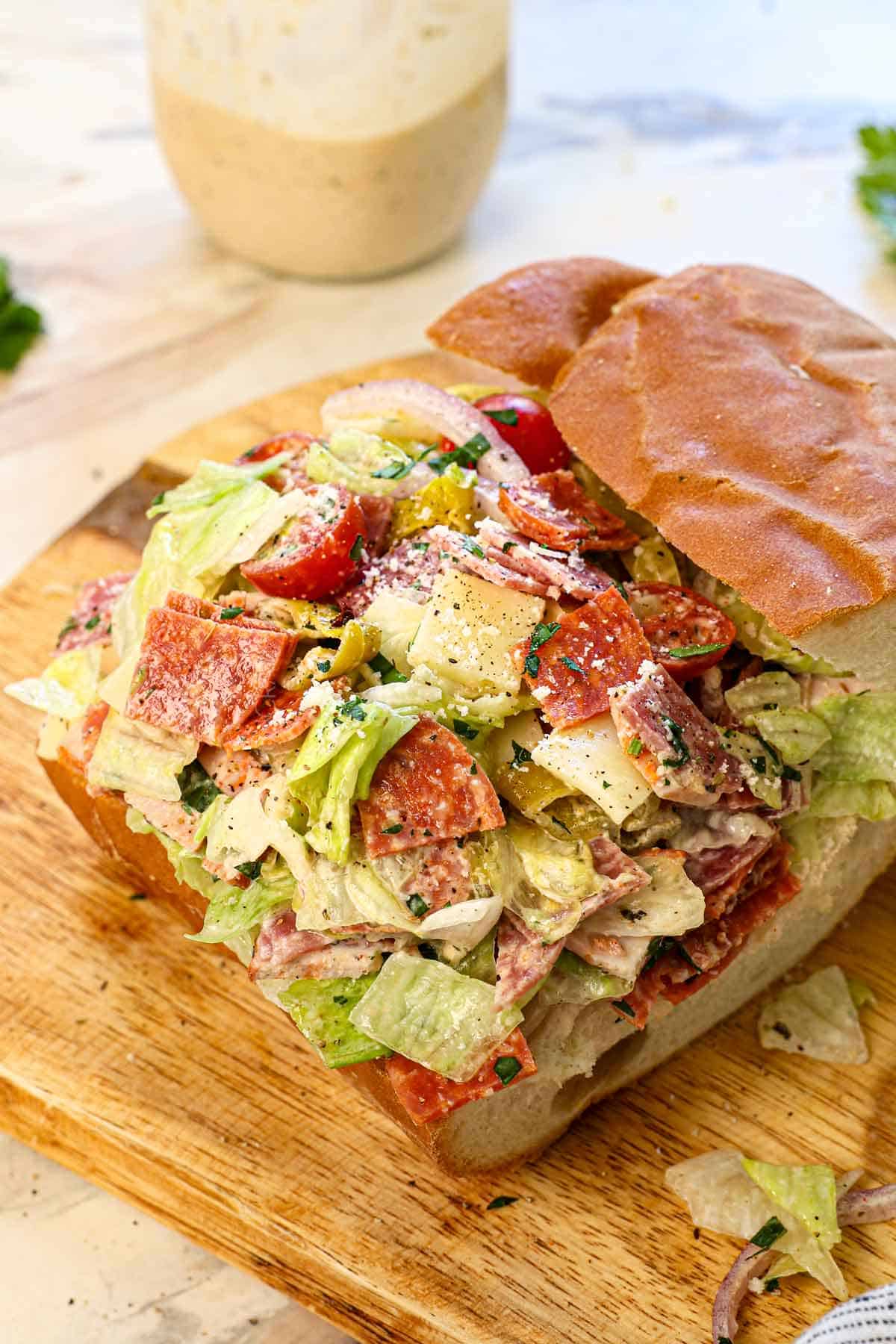 showing how to serve Grinder Salad by placing it in bread to make a sandwich