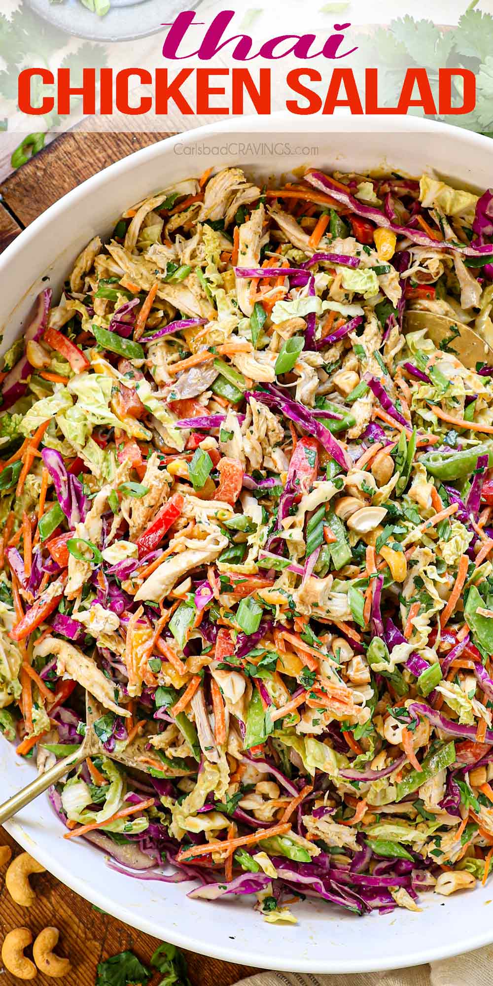 top view of Thai Chicken Salad in a large serving bowl tossed with Thai peanut dressing