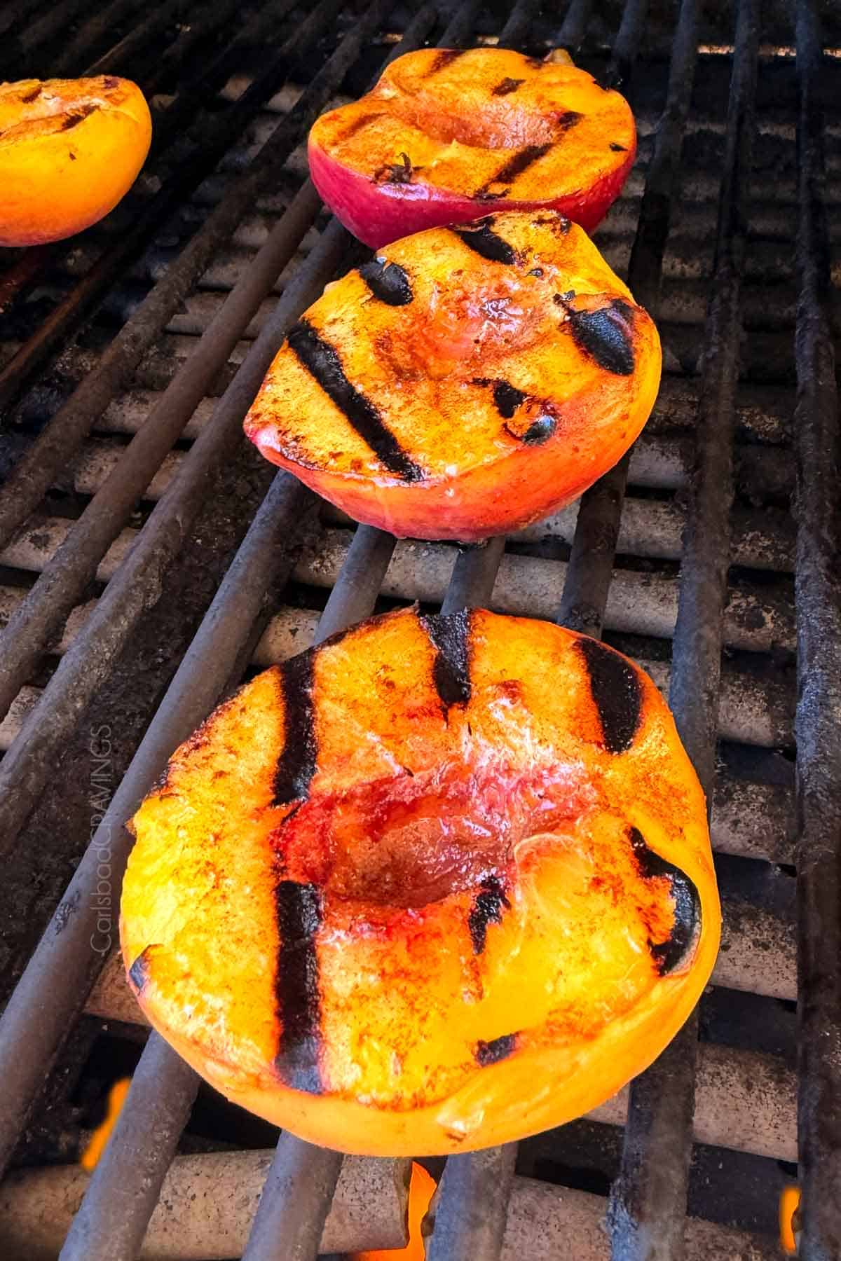 showing how to grill peaches on a grill until grill marks appear and the peaches are tender