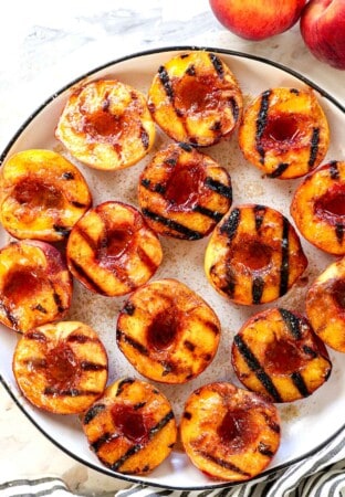 showing how to grill peaches by sprinkling with brown sugar after they are grilled