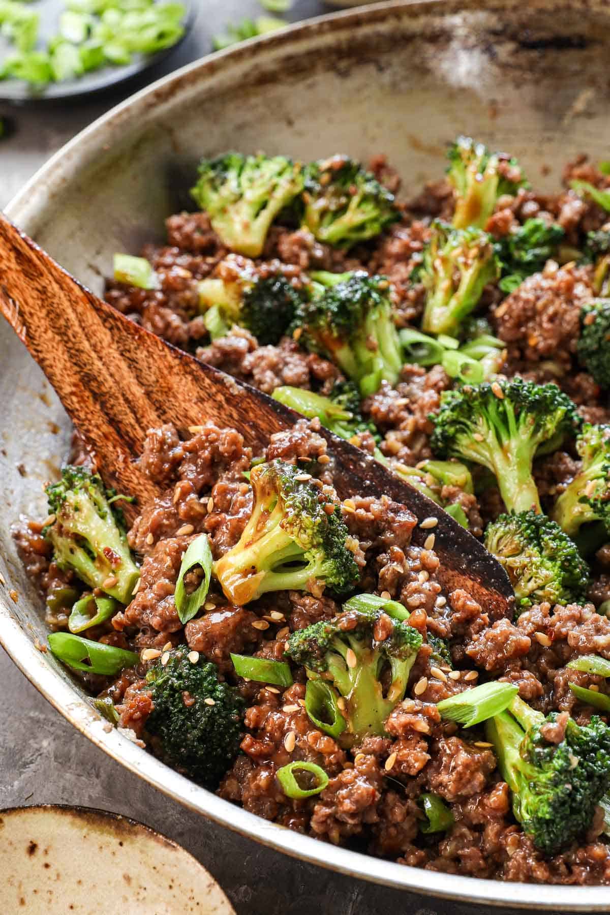 up close of scooping up ground beef and broccoli showing how juicy the meat is