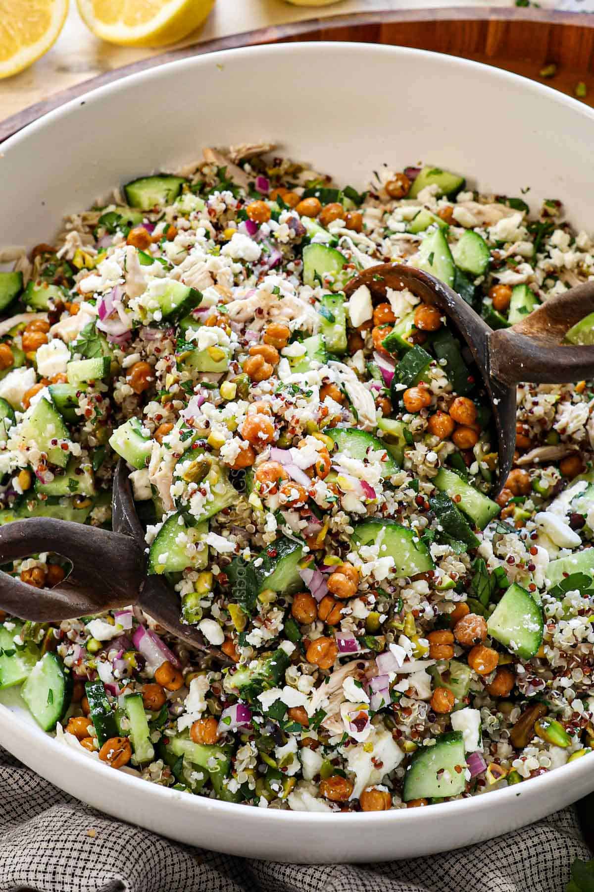 Tossing Jennifer Aniston quinoa salad together