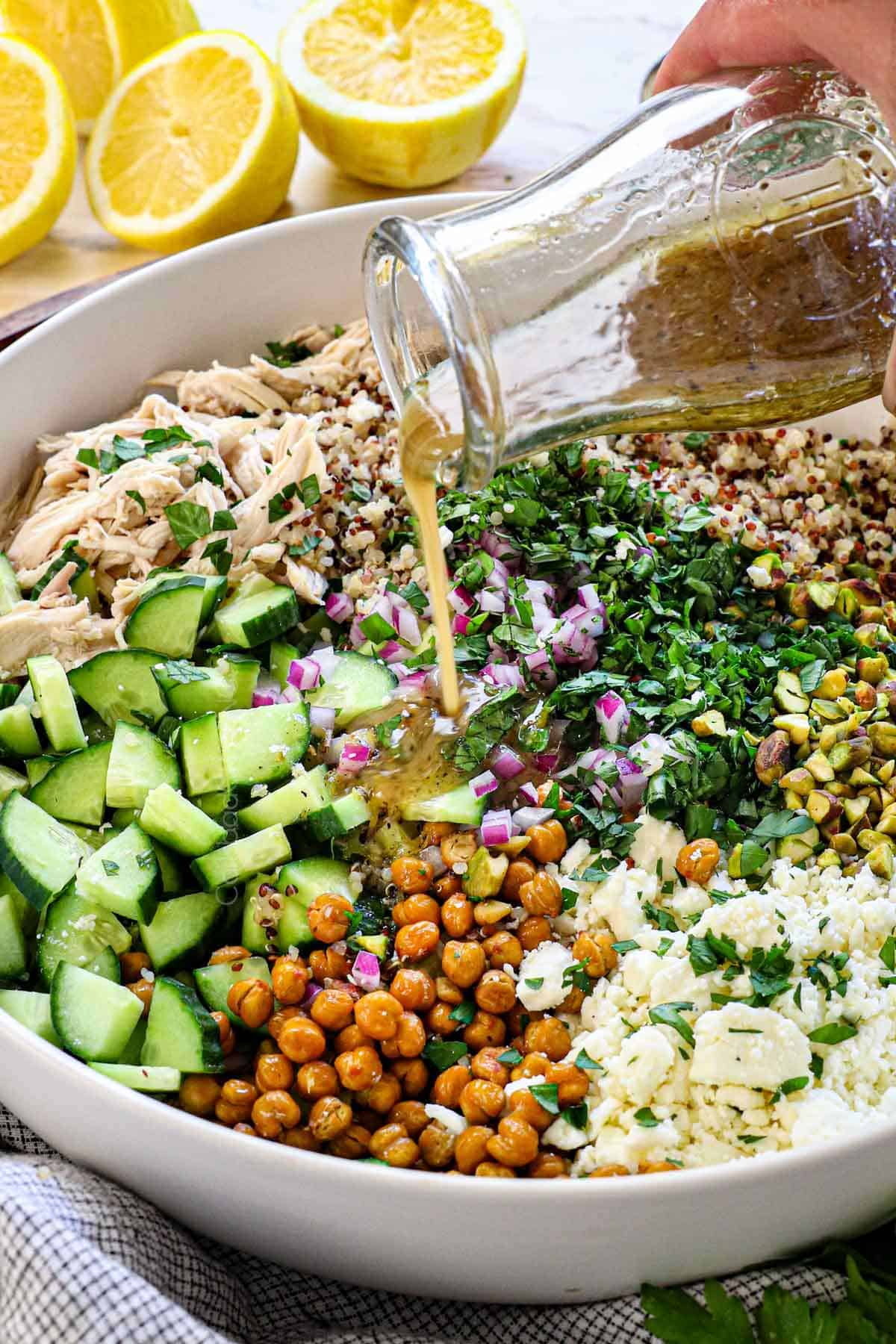 shoiwng how to make Jennifer Aniston Salad recipe by drizzling with Lemon Dressing