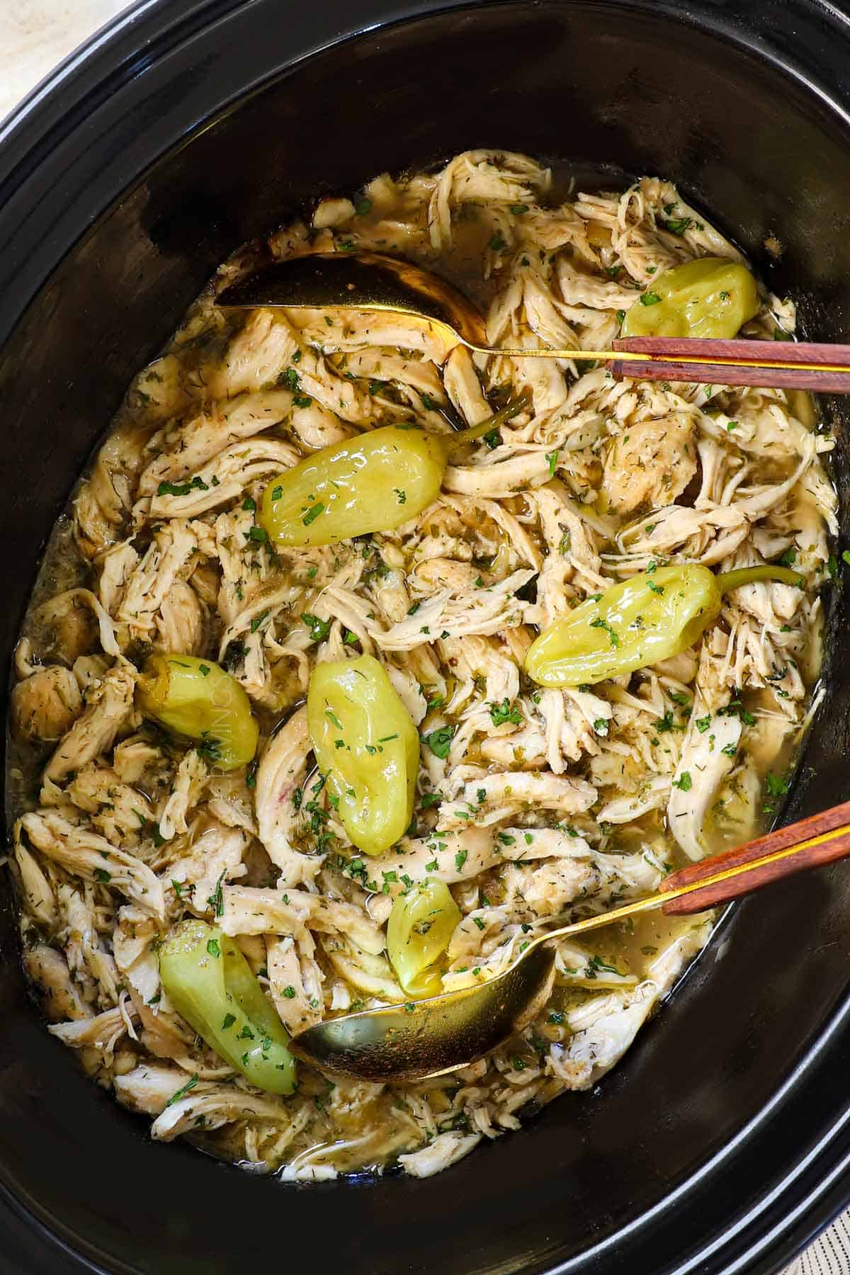 top view of Mississippi Chicken recipe in the crockpot showing the shredded chicken in the gravy