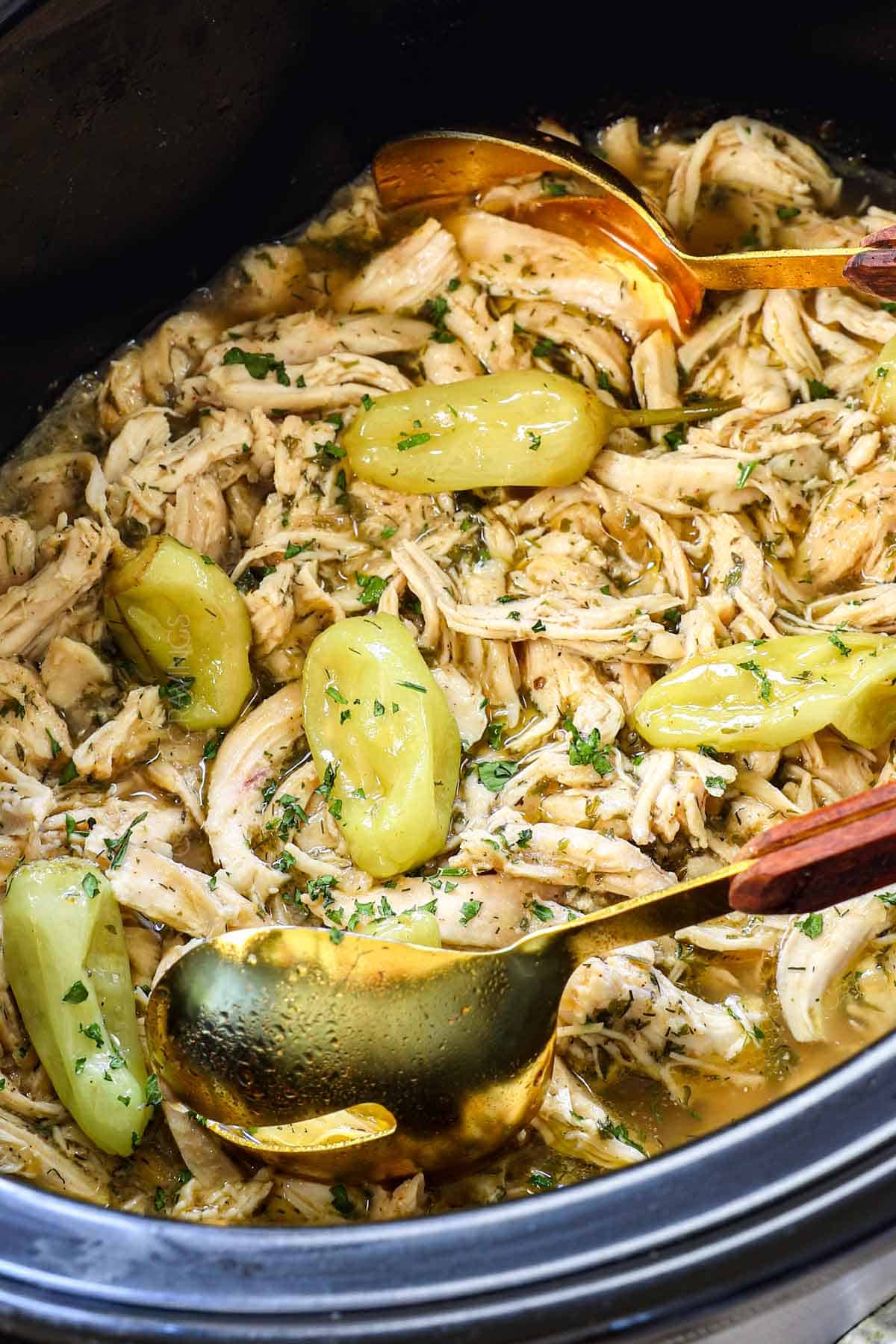showing how to make Mississippi Chicken by shredding the chicken and letting it soak in the gravy
