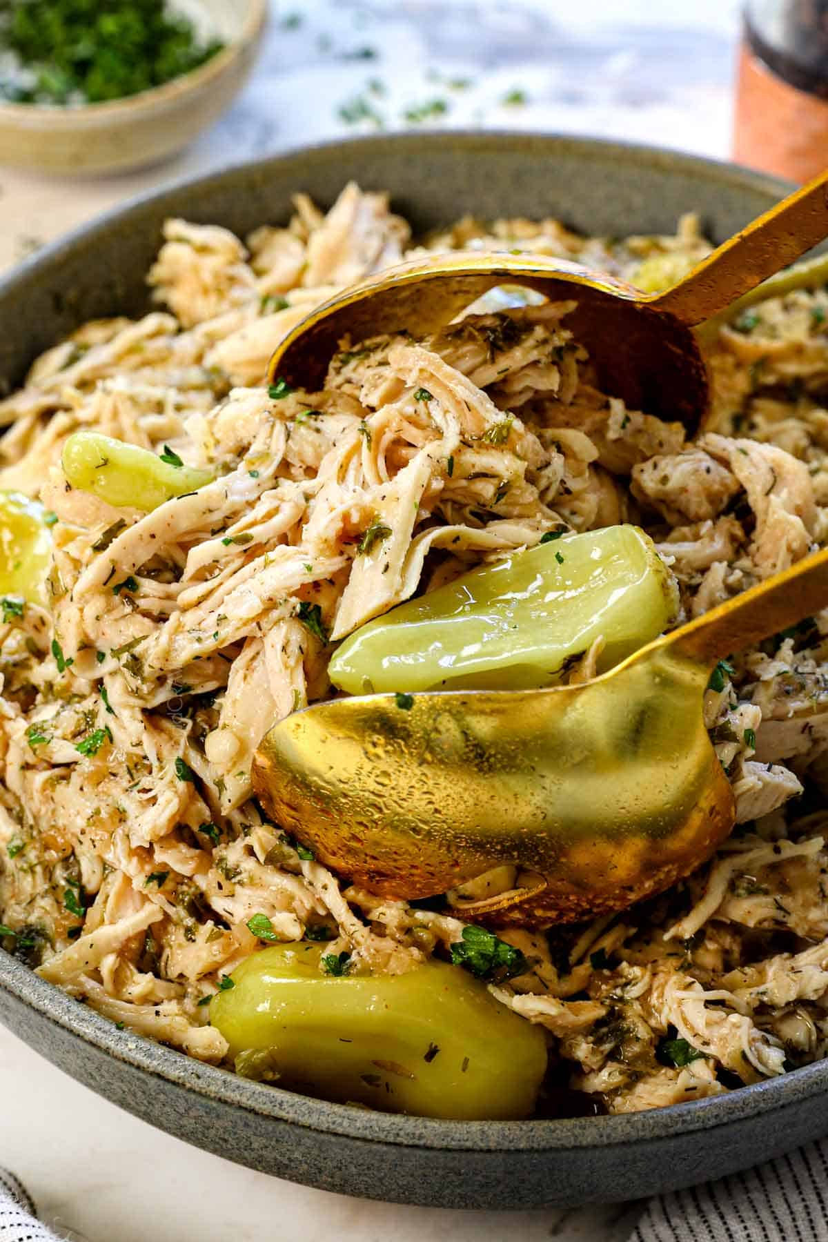 serving the crockpot Mississippi Chicken with tongs