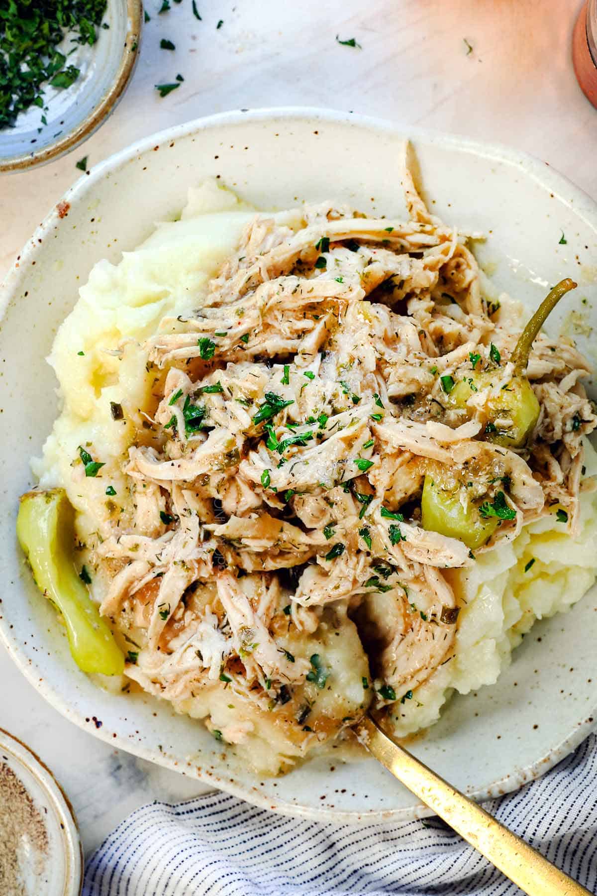 showing how to serve Mississippi chicken over mashed potatoes