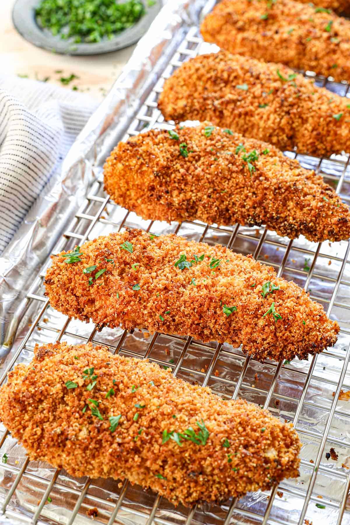 crispy baked chicken strips (tenders) on a baking sheet