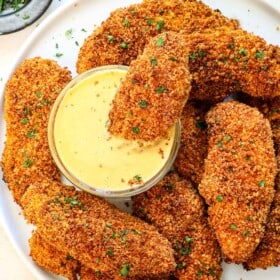 chicken tenders breaded in panko on a platter garnished with parsley