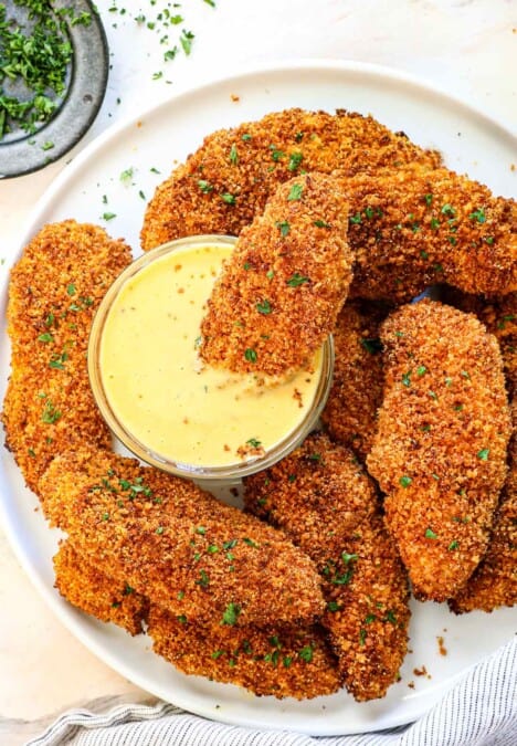 chicken tenders breaded in panko on a platter garnished with parsley