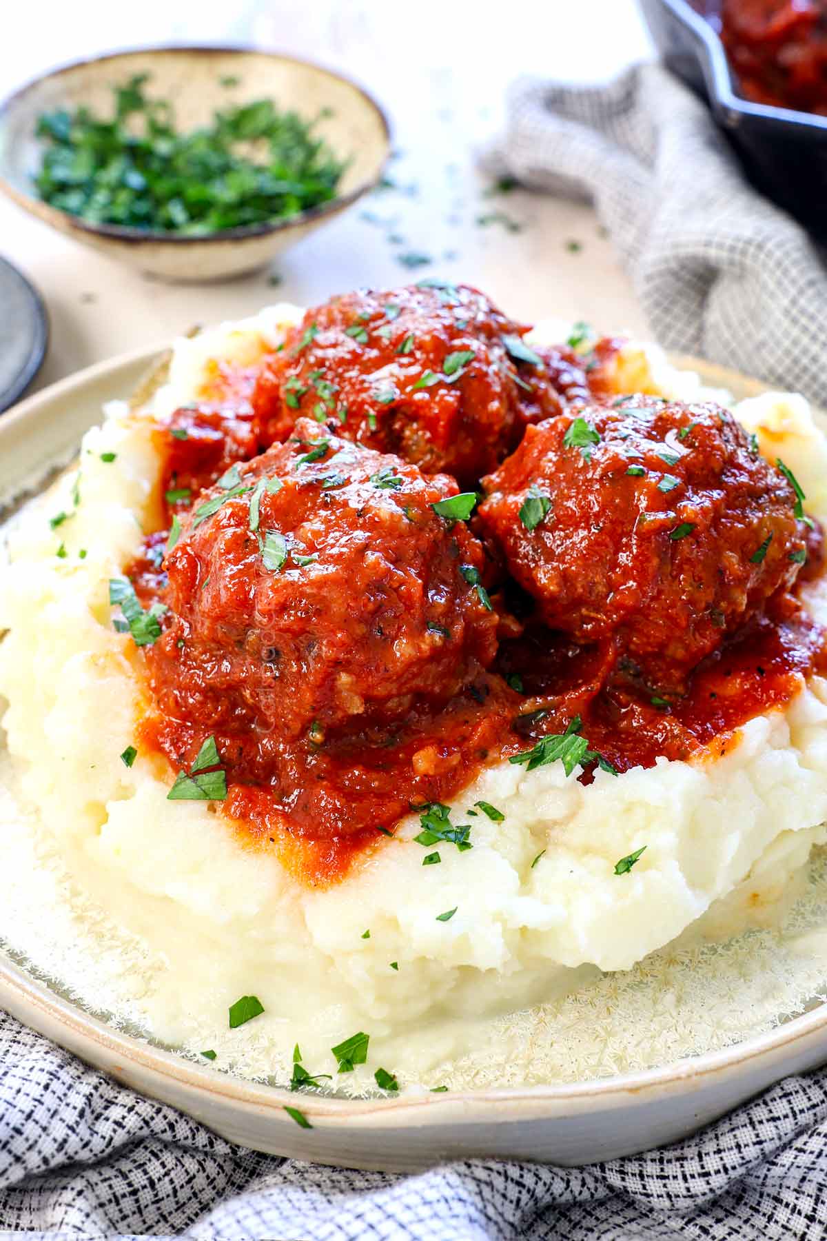 juicy porcupine meatballs being served over mashed potatoes