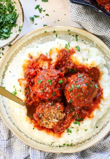 showing how to serve porcupine meatballs on a plate with mashed potatoes