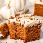 a slice of pumpkin cake with a bite taken out showing how moist it is