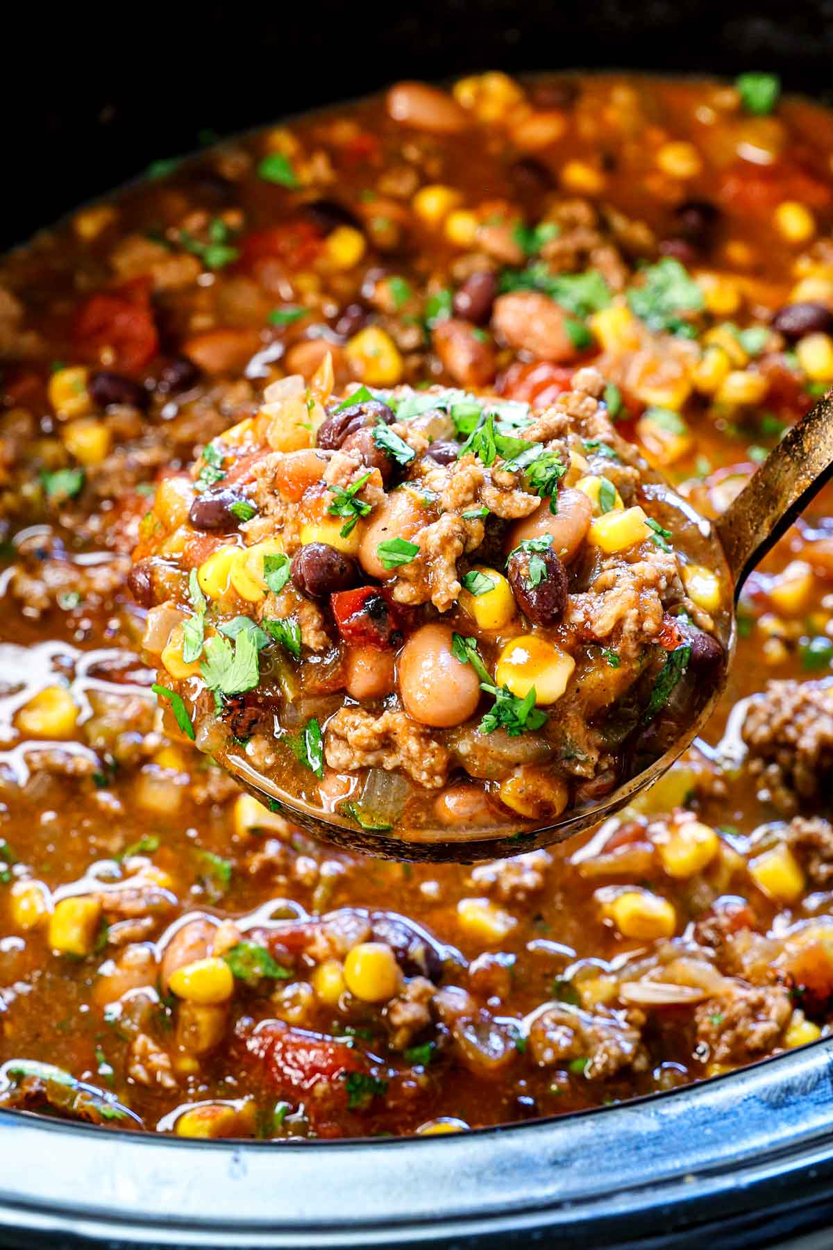 showing how to make taco soup by slow cooking until the beans are tender