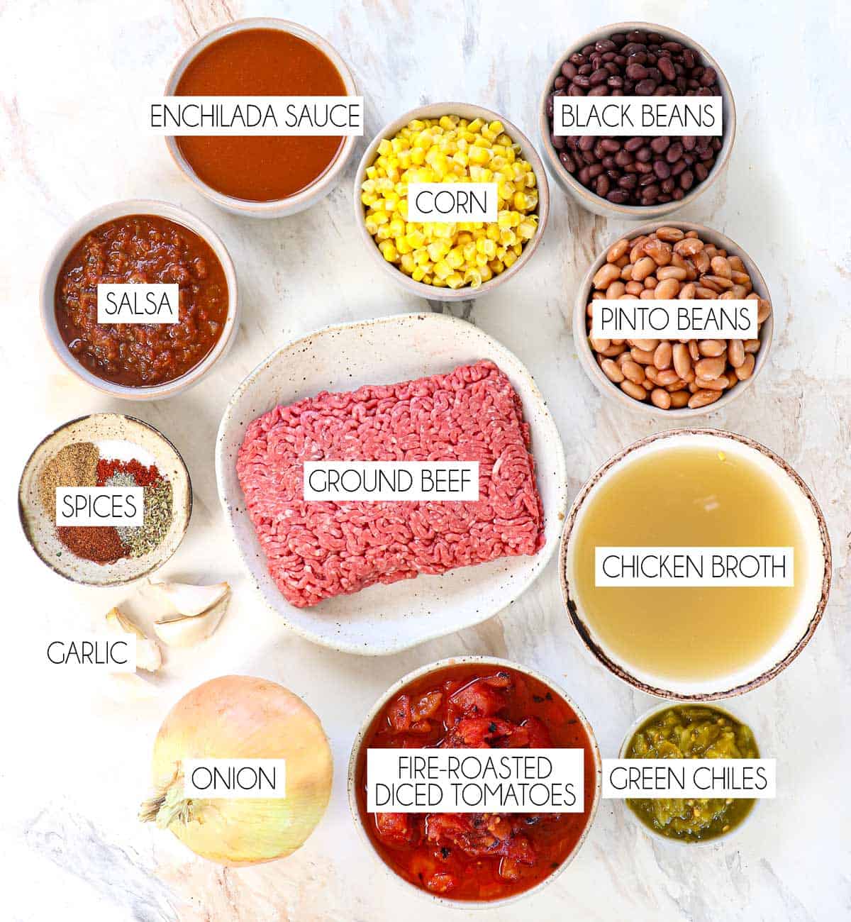 Top view of Crockpot Taco Soup recipe ingredients: ground beef, black beans, pinto beans, corn, salsa, diced tomatoes, green chiles, onion, garlic, chicken broth, homemade taco seasoning