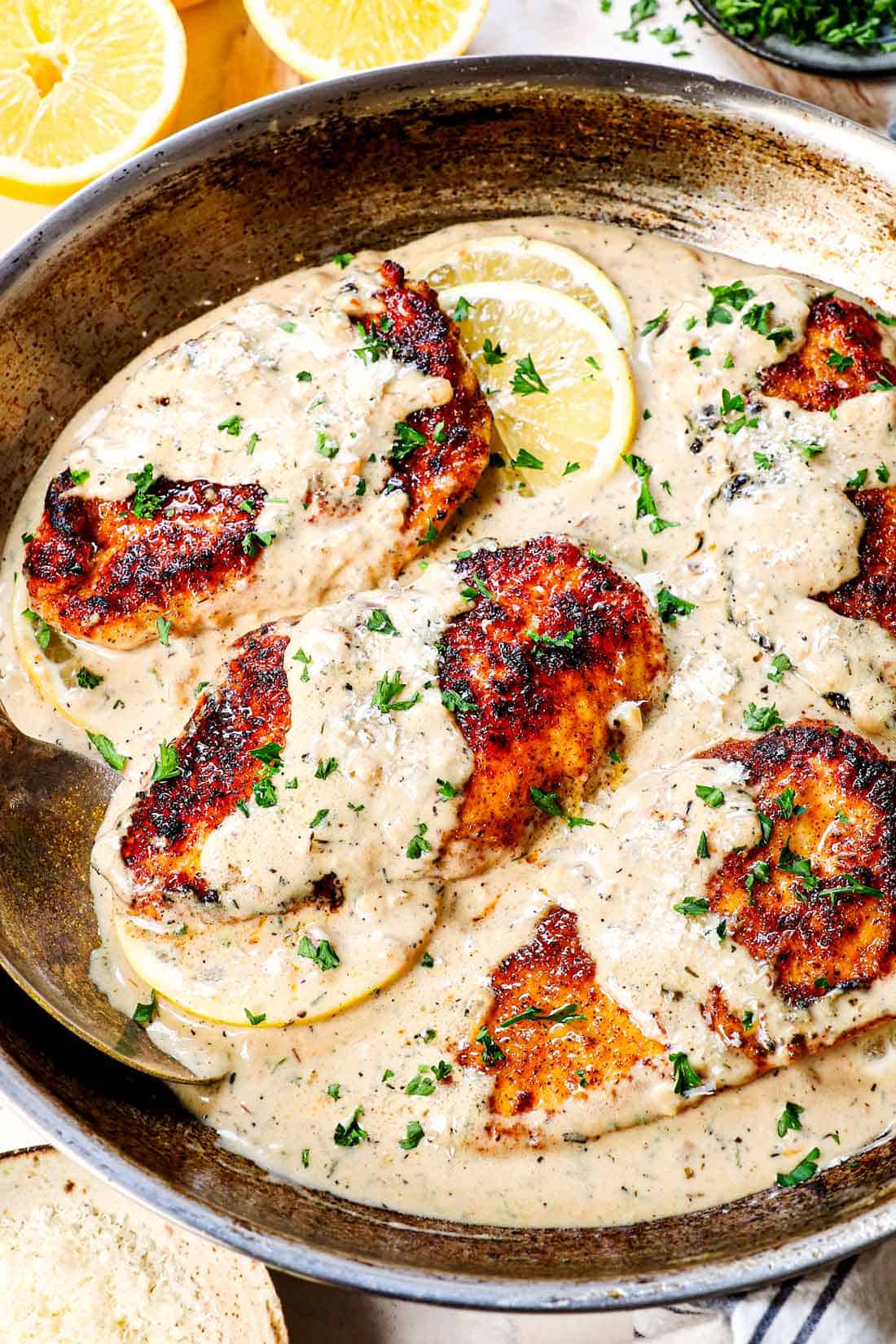 lemon chicken recipe in a skillet garnished by parsley