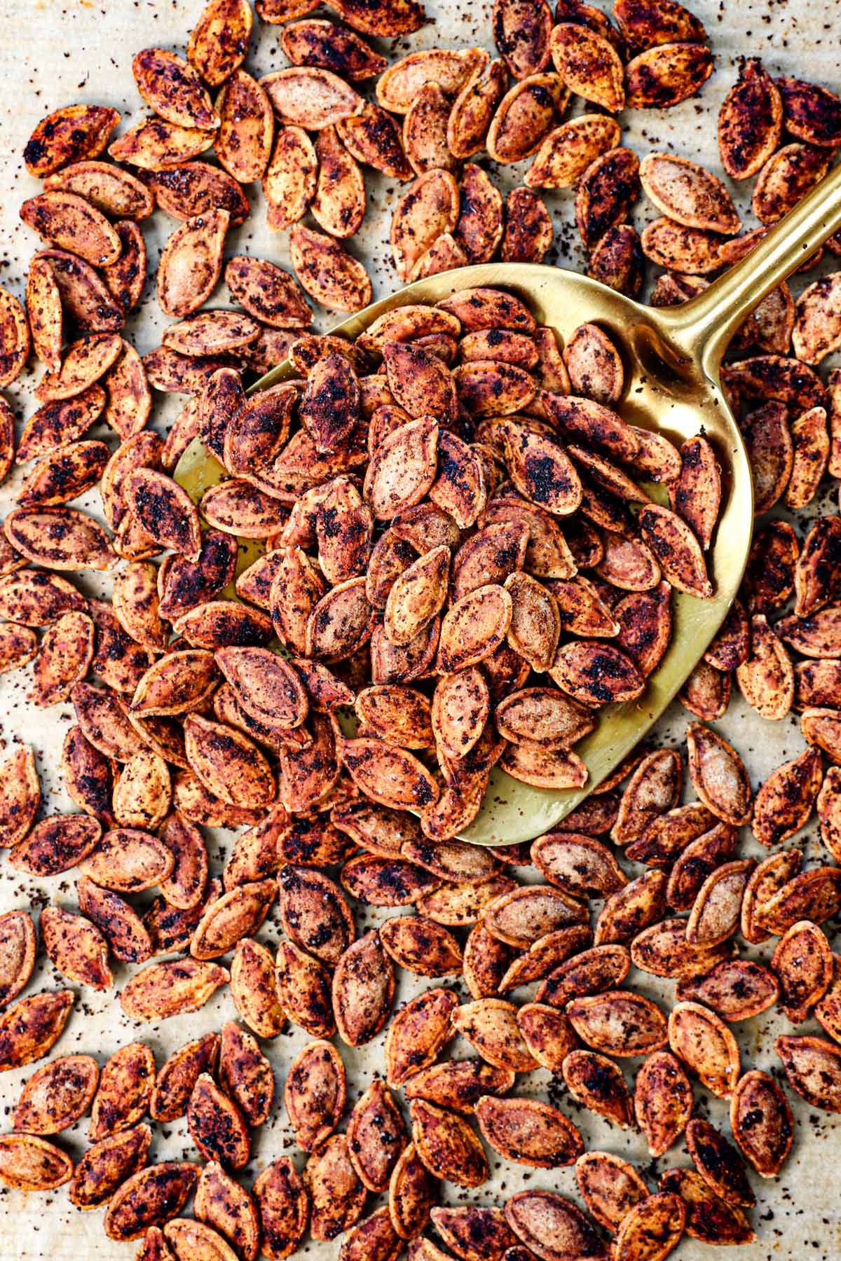 showing how to roast pumpkin seeds until crispy by letting cool on the baking sheet