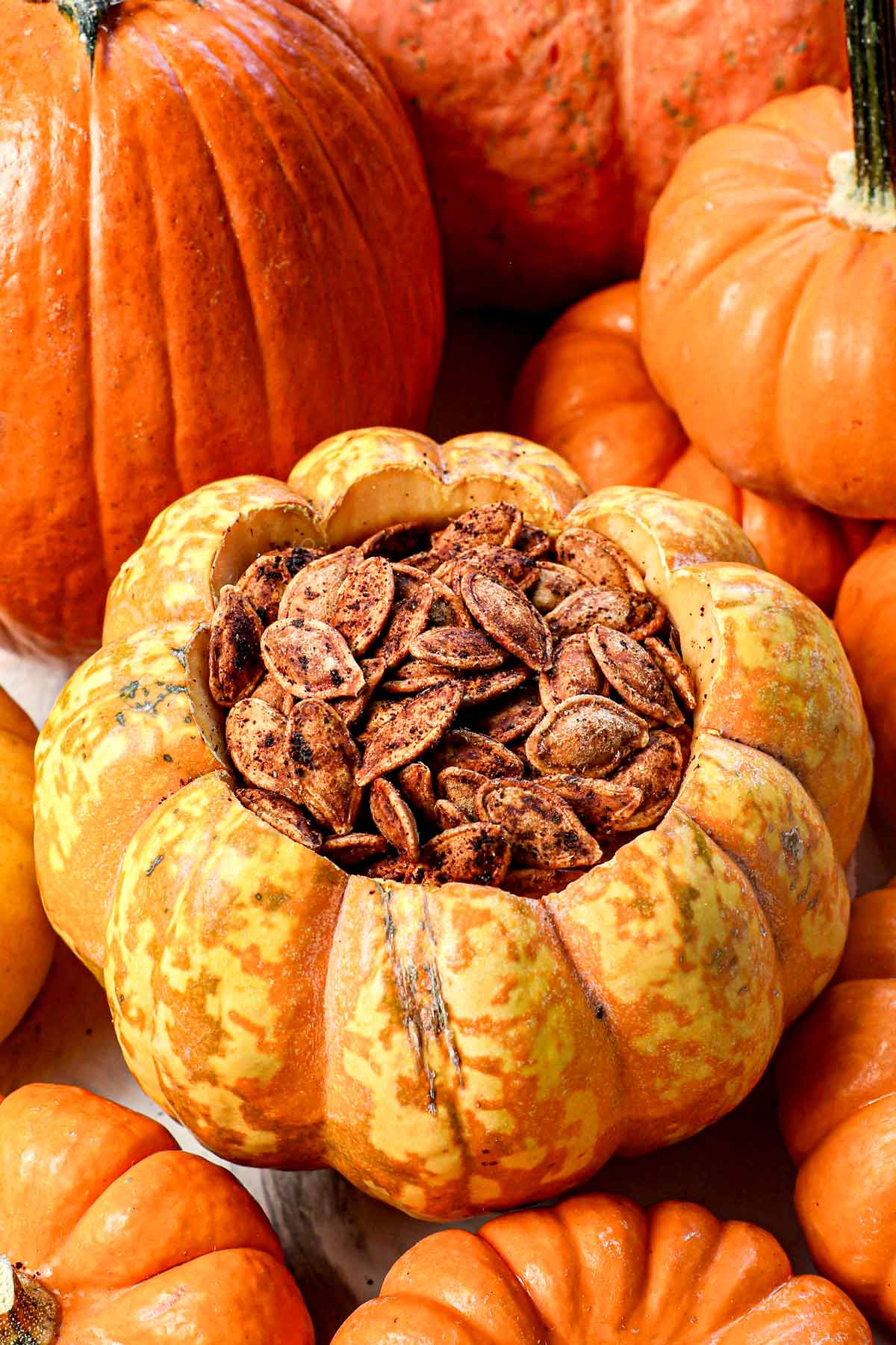 up close of roasted pumpkin seeds coated in spices showing how crispy they are