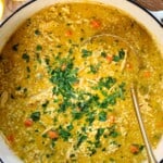 top view of Penicillin Soup in a large Dutch oven garnished with fresh parsley