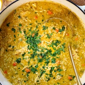 top view of Penicillin Soup in a large Dutch oven garnished with fresh parsley
