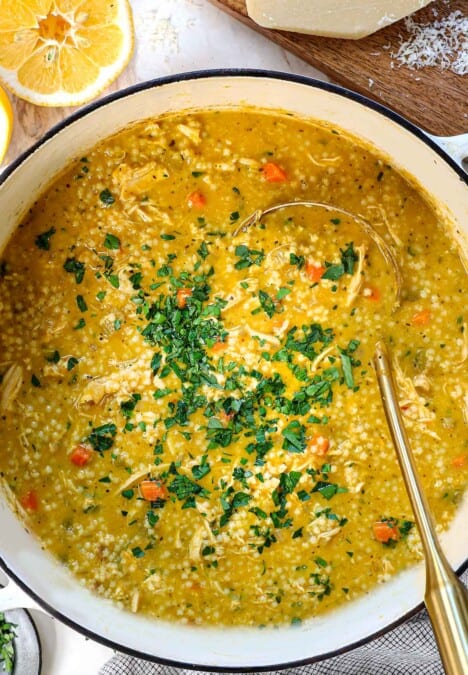 top view of Penicillin Soup in a large Dutch oven garnished with fresh parsley