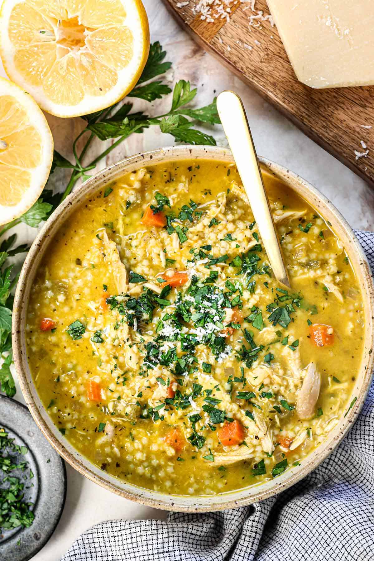 showing how to serve Penicillin Soup (pastina soup) recipe in a bowl garnished with fresh parsley and Parmesan